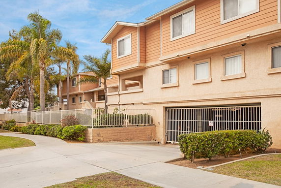 Front view of a multi-story residential building with garage.