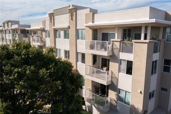 Front view of a multi-story residential apartment building with balconies.