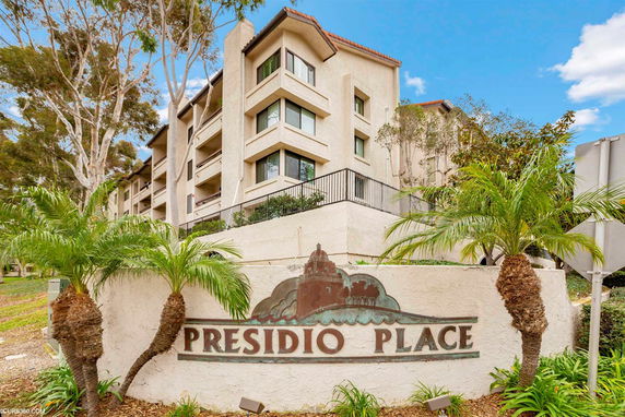 Front view of a multi-story building with balconies and a sign labeled Presidio Place.