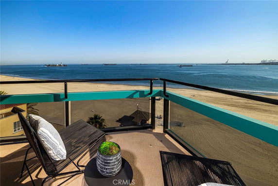 Panoramic view from a balcony overlooking the beach and sea.