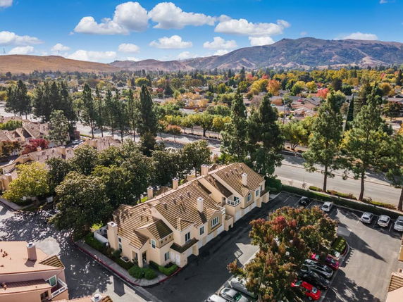 Wide-angle view of residential buildings with a mountainous backdrop.