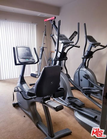 Indoor gym area with exercise equipment.