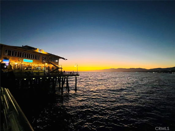 Panoramic view of a waterfront building at sunset
