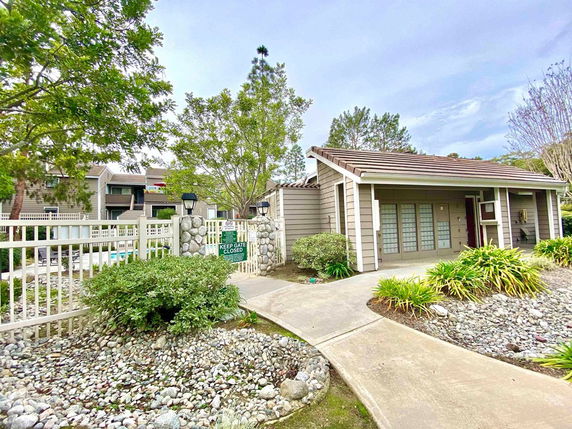 Front view of a single-story house with a garden path leading to the entrance.