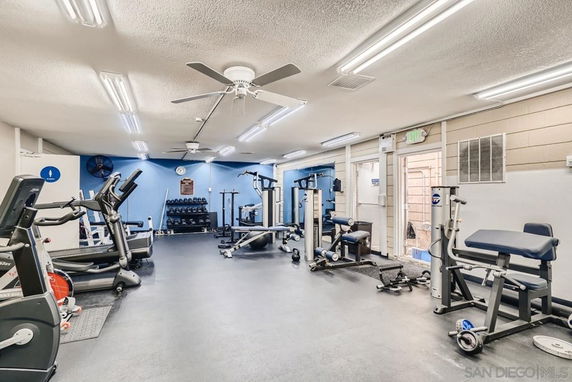 Interior of a gym with various exercise equipment and machines.