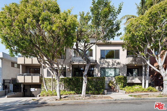 Front view of a two-story residential building with multiple balconies.