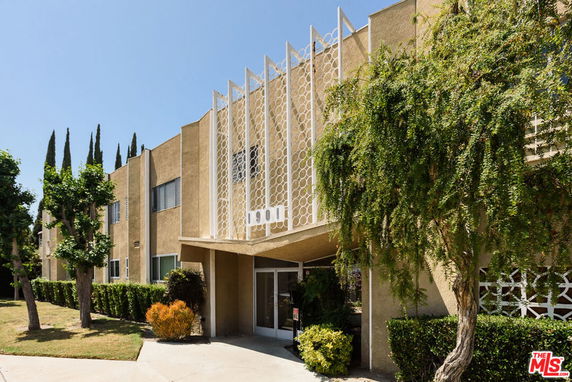 Front view of a two-story building with decorative facade elements.