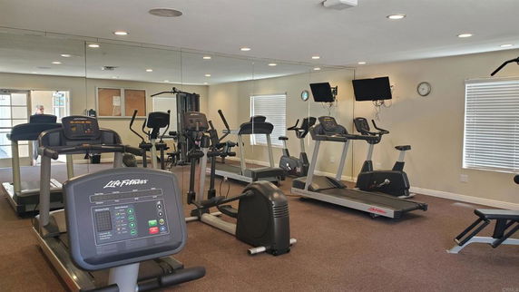 Gym area with treadmills and exercise equipment.
