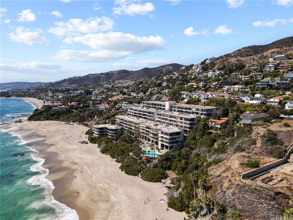 Panoramic view of a coastal area with buildings along a beach.