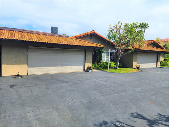 Front view of a house with a double garage and tiled roof.