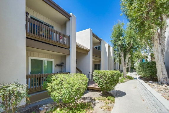 Front view of a multi-story residential building with balconies.