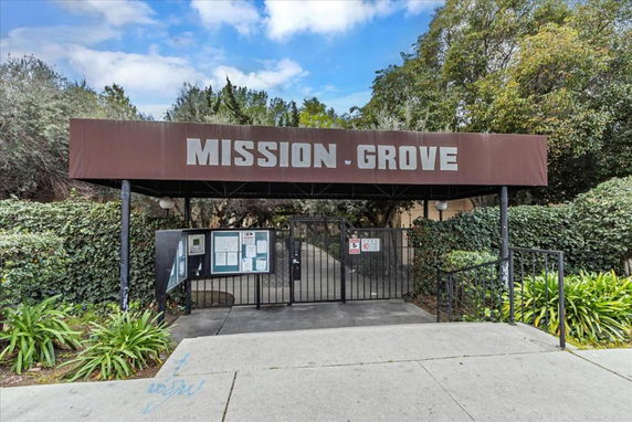Front view of a building entrance with a canopy labeled Mission Grove.