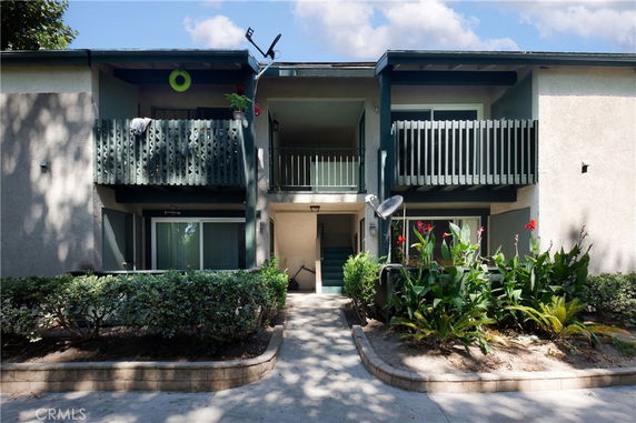 Front view of a two-story apartment building with balconies.
