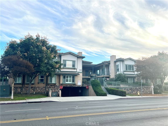 Front view of a two-story residential building with a garage entrance.