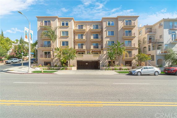 Front view of a multi-story apartment building with balconies.