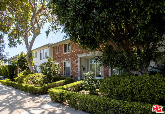 Front view of a two-story brick house with white accents.