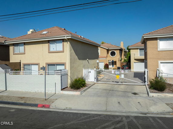 Front view of a residential building with a gated entrance.