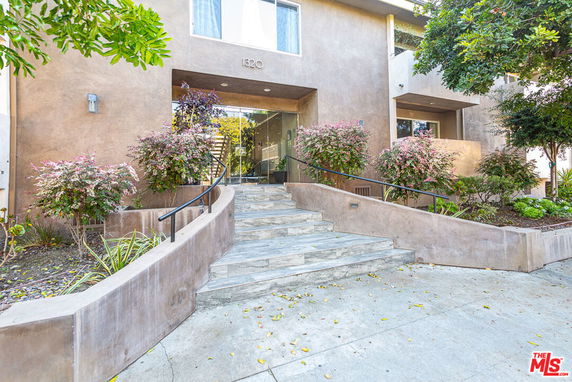 Front view of a building with steps leading to the entrance.