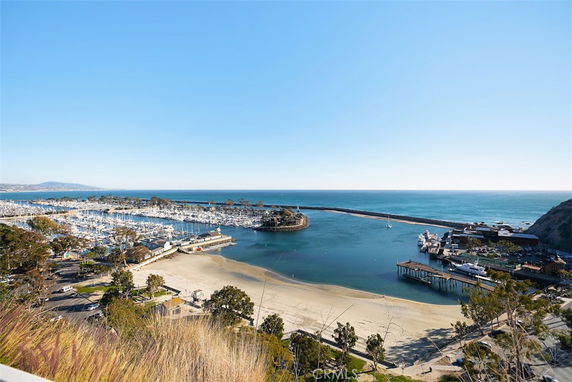 Panoramic view of a marina and coastline with boats docked along the shore.