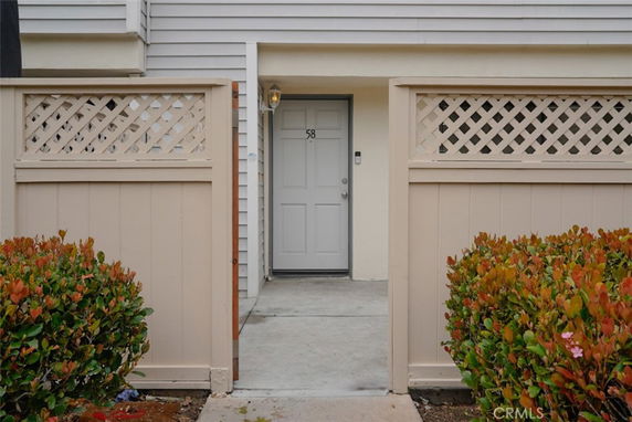 Front view of a house entrance with a small gate and pathway.