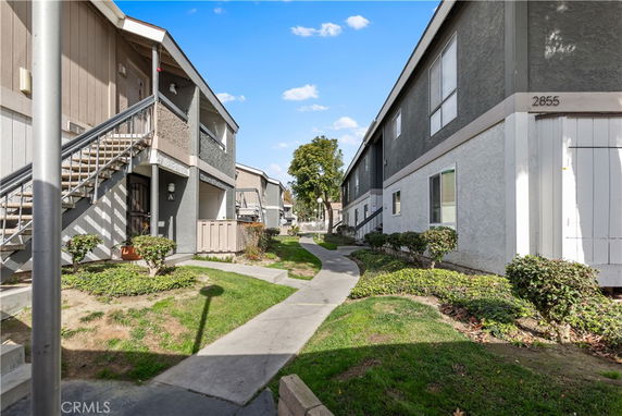 View of a residential building with multiple entrances and pathways.