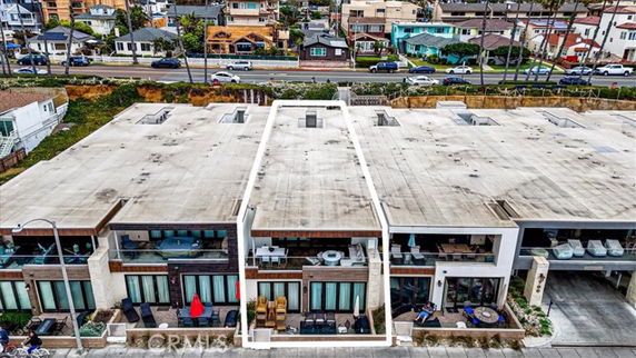 Rooftop view of connected flat-roofed buildings in a residential area.