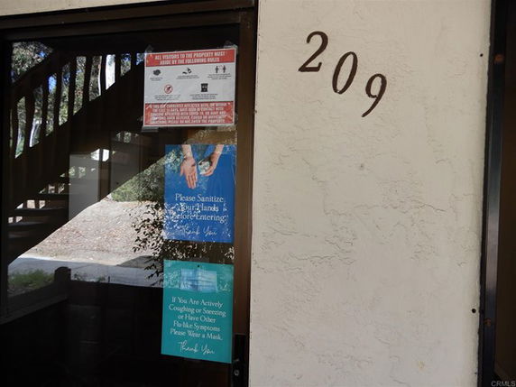 Front view of a building entrance with the number 209.