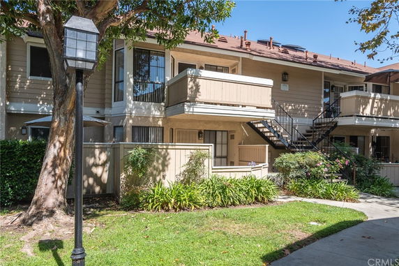 Front view of a two-story apartment building with balconies.