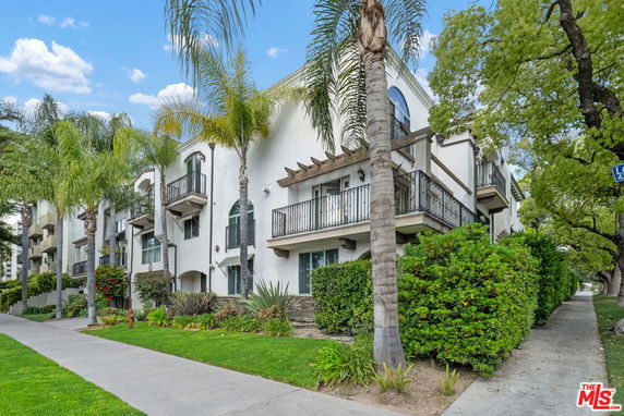 Front view of a multi-story residential building with balconies.
