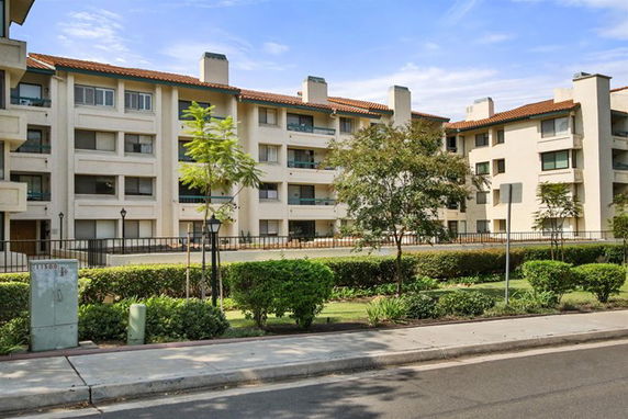 Front view of a multi-story apartment building with balconies.