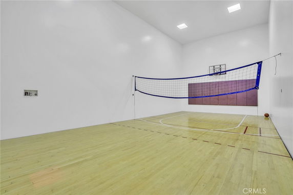 Indoor play area with a basketball hoop and a volleyball net.