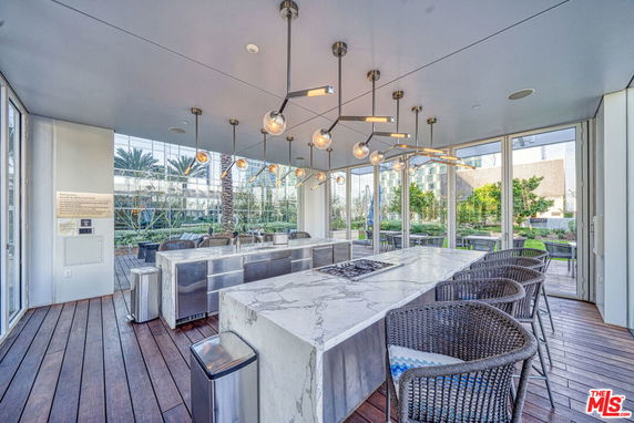 Indoor clubhouse area with seating and a marble counter setup.