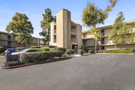 Front view of a multi-story building with balconies.