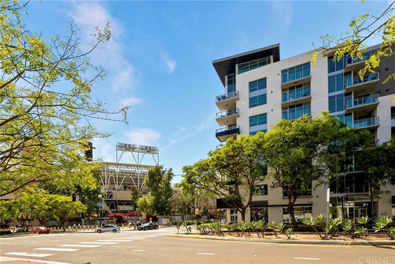 Front view of a multi-story apartment building with balconies.