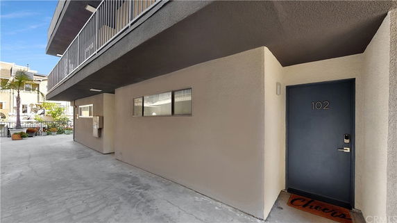 Entry view of a building with unit number 102 visible.