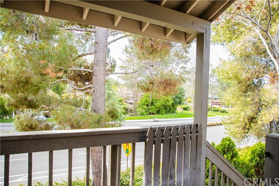View from a structure looking out towards a tree-lined street.