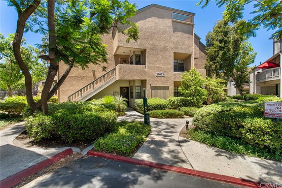 Front view of a multi-story building with an exterior staircase.