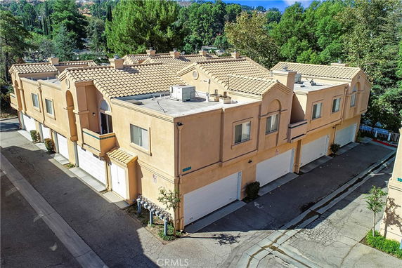 Front view of a two-story building with multiple garages.