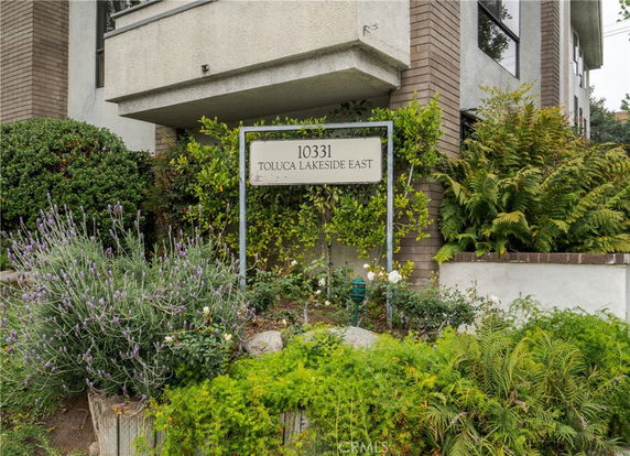 Front view of a multi-story building with a sign reading 'TOLUCA LAKESIDE EAST'.