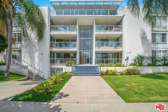 Front view of a multi-story building with balconies.