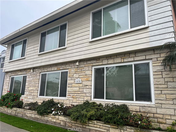 Front view of a two-story building with stone and siding facade.