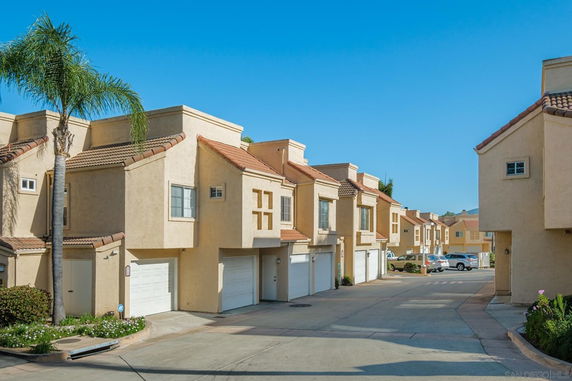 Front view of a row of townhouses with garages.