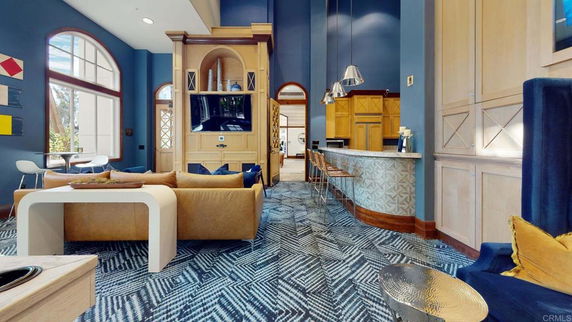 Interior of a clubhouse with seating area and bar counter.