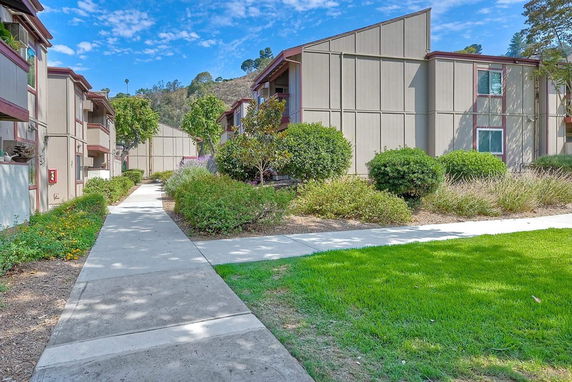 Pathway between apartment buildings with landscaping