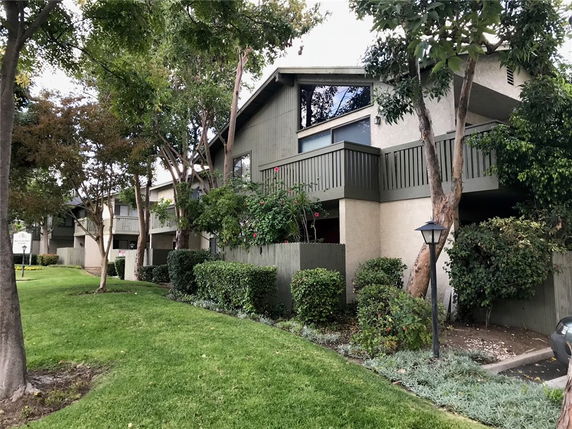 Front view of a multi-story residential building with balconies.