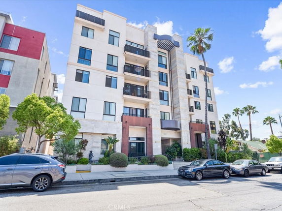 Front view of a multi-story apartment building with modern architectural design.
