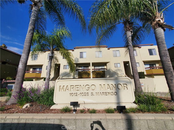 Front view of a multi-story apartment building named Marengo Manor.