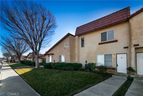 Front view of a two-story residential building with multiple units.
