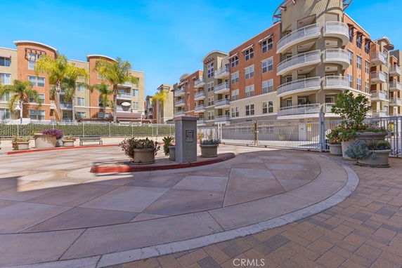 Front view of a multi-story residential building with balconies.