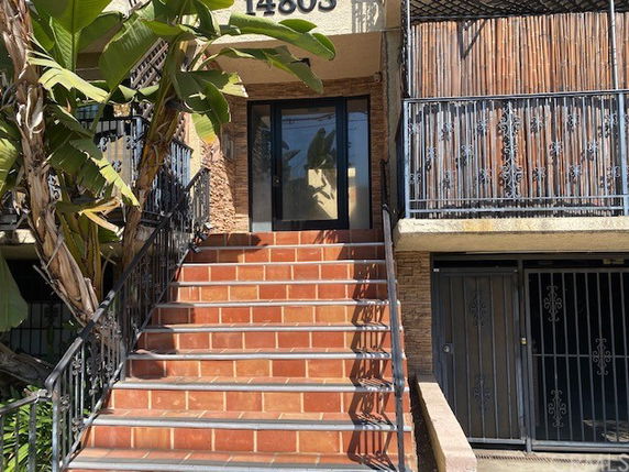 Front view of a building entrance with tiled steps.